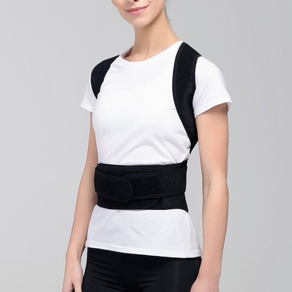 Person wearing a black posture corrector on a gray background
