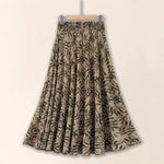 Floral patterned skirt on a hanger against a beige background