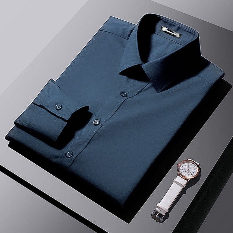 Folded navy blue dress shirt with a white wristwatch on a gray surface