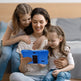 Woman and two children sitting on a bed using a tablet together.