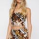 Woman wearing a colorful sequin outfit on a white background