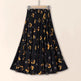 Black skirt with gold floral pattern on a beige background