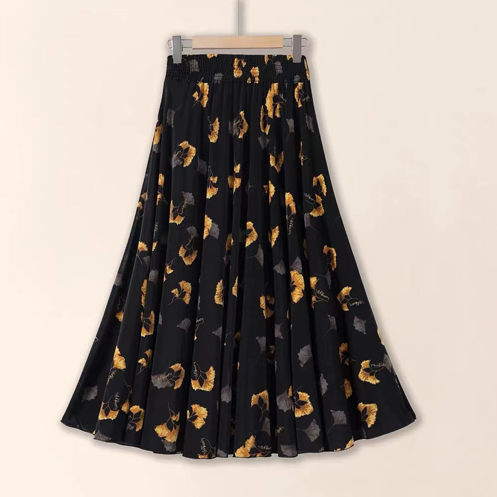 Black skirt with gold floral pattern on a beige background