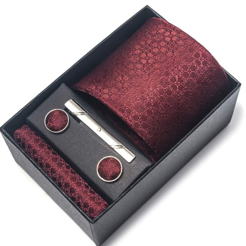 Maroon patterned tie set with tie clip and pocket square in a black box on a white background