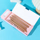 Set of wooden pencils in a pink case on a blue background