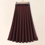 Brown skirt on a hanger against a beige background