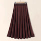 Brown skirt on a hanger against a beige background