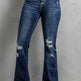 Distressed blue jeans on a plain background