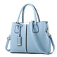 Light blue handbag with a shoulder strap on a white background
