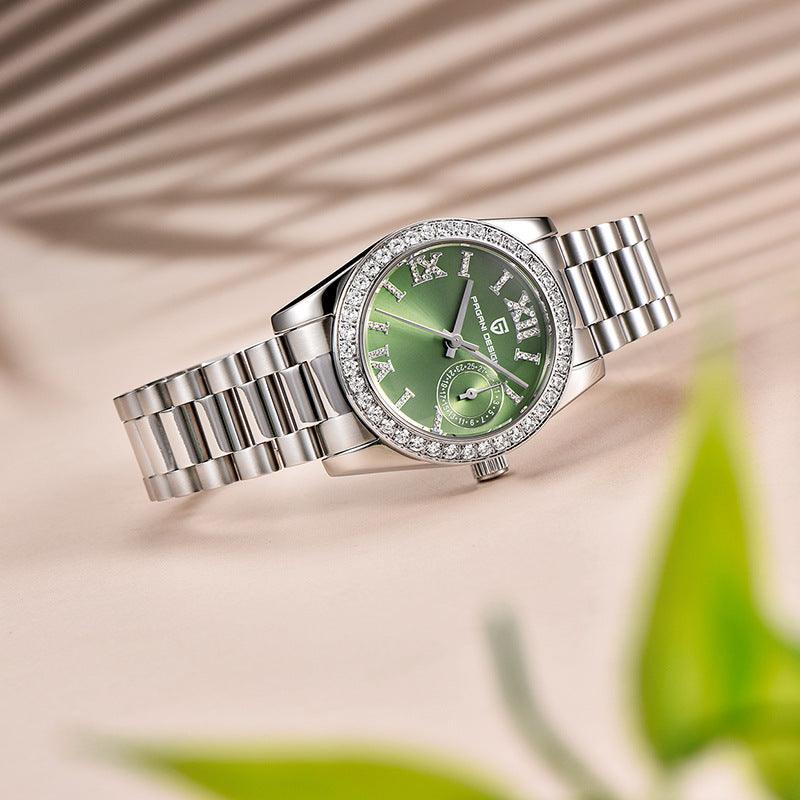 Silver watch with a green face on a beige background