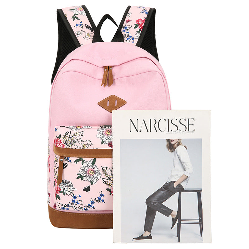 Pink backpack with floral straps and pocket, next to a magazine titled 'Narcisse'.