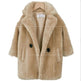 Beige faux fur coat with black buttons on a white background
