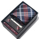 Tie, cufflinks, and tie clip set with plaid pattern in a black box on a white background