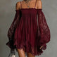 Woman wearing a burgundy off-shoulder dress with sheer sleeves against a gray background