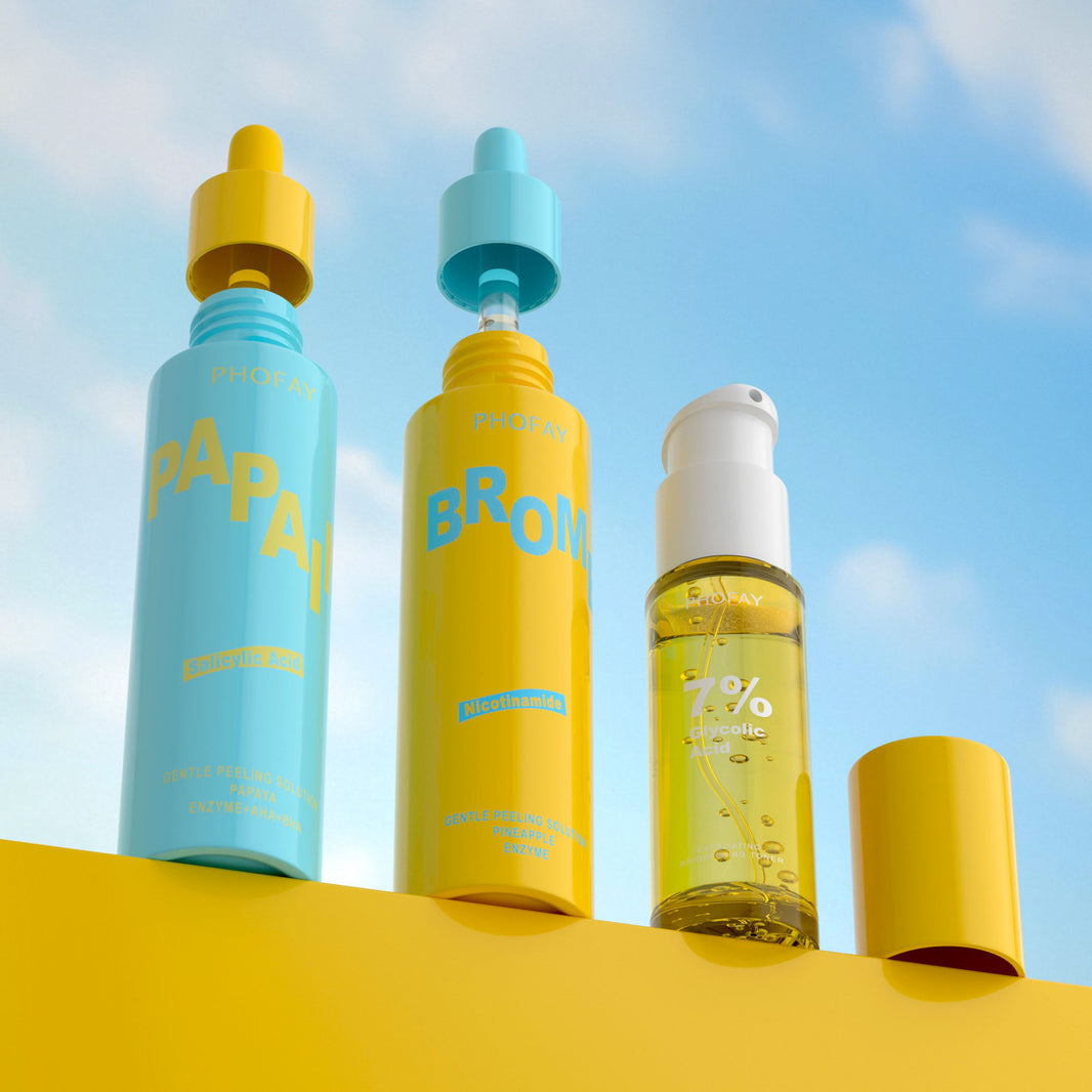 Three skincare bottles with colorful caps against a blue sky background