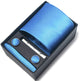 Blue tie set with pocket square, clip, and cufflinks in a black box on a white background