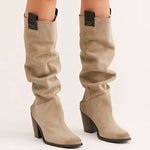 Beige knee-high boots with black block heels on a white background
