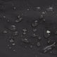 Close-up of water droplets resting on a dark, matte, waterproof surface.