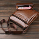 Brown leather shoulder bag with a smaller pouch on a wooden surface