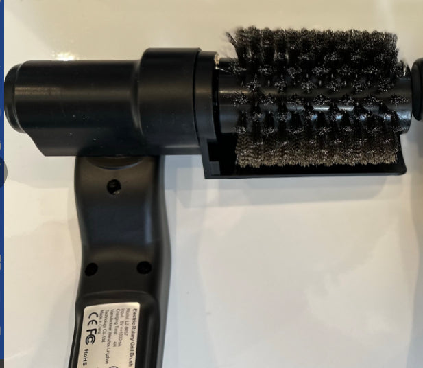 Black handheld brush with bristle head on a white background