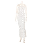 Mannequin wearing a polka dot dress on a white background