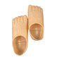 A pair of novelty foot-shaped slippers or molds in a flesh-toned beige color, shown against a plain white background.