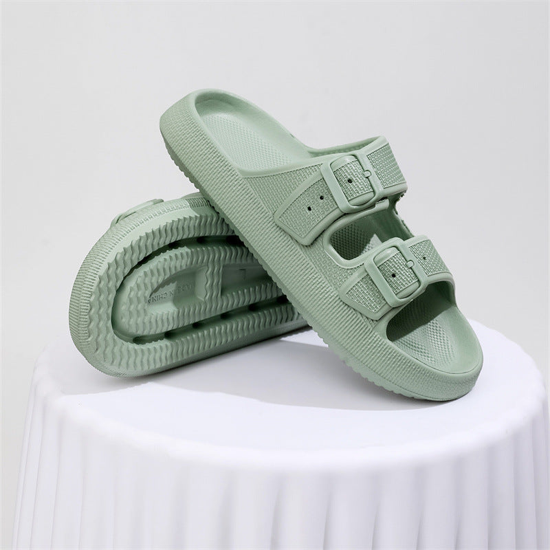 Pair of light green sandals on a white surface with a light gray background