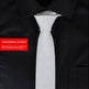 Gray tie on a black suit with a red item number label.