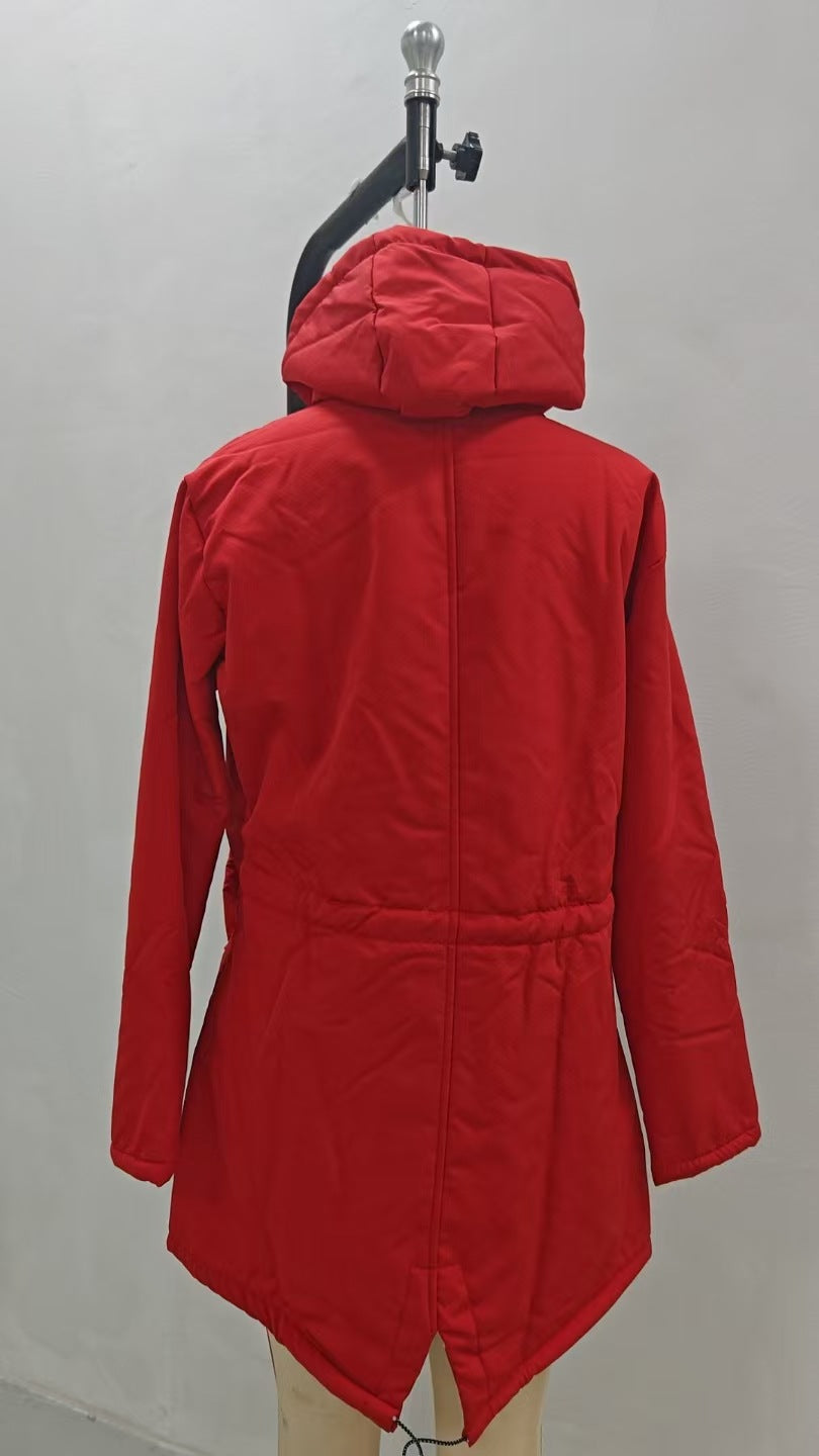 A bright red hooded puffer jacket displayed on a dress form mannequin against a plain light gray wall.
