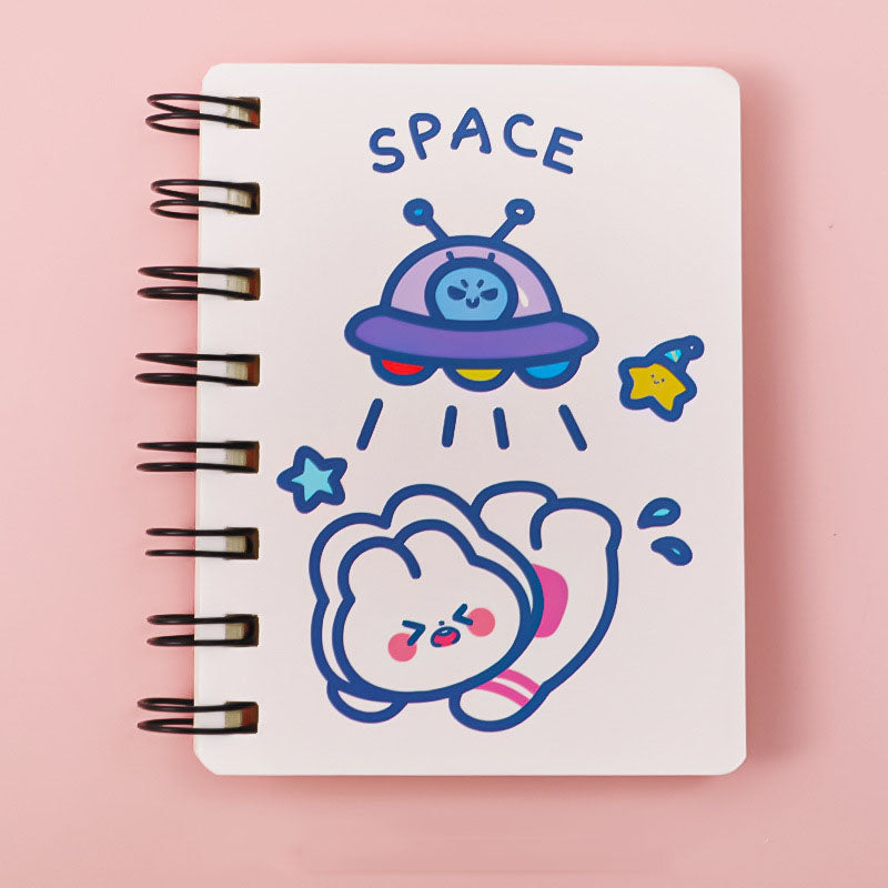Notebook with space-themed illustrations on a pink background
