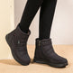 Black winter boots worn with black leggings on a neutral background