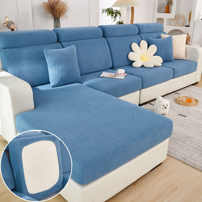 Blue sectional sofa with a close-up of a cushion in a living room setting.