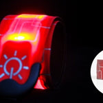 Red and black reflective safety belt with light on a dark background