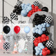 Balloon arch with red, blue, and black balloons, checkered flags, and race car elements.