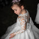 Young girl in a white lace dress with a dark background