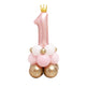 Pink balloon sculpture shaped like the number '1' with a gold crown on top, surrounded by smaller balloons.