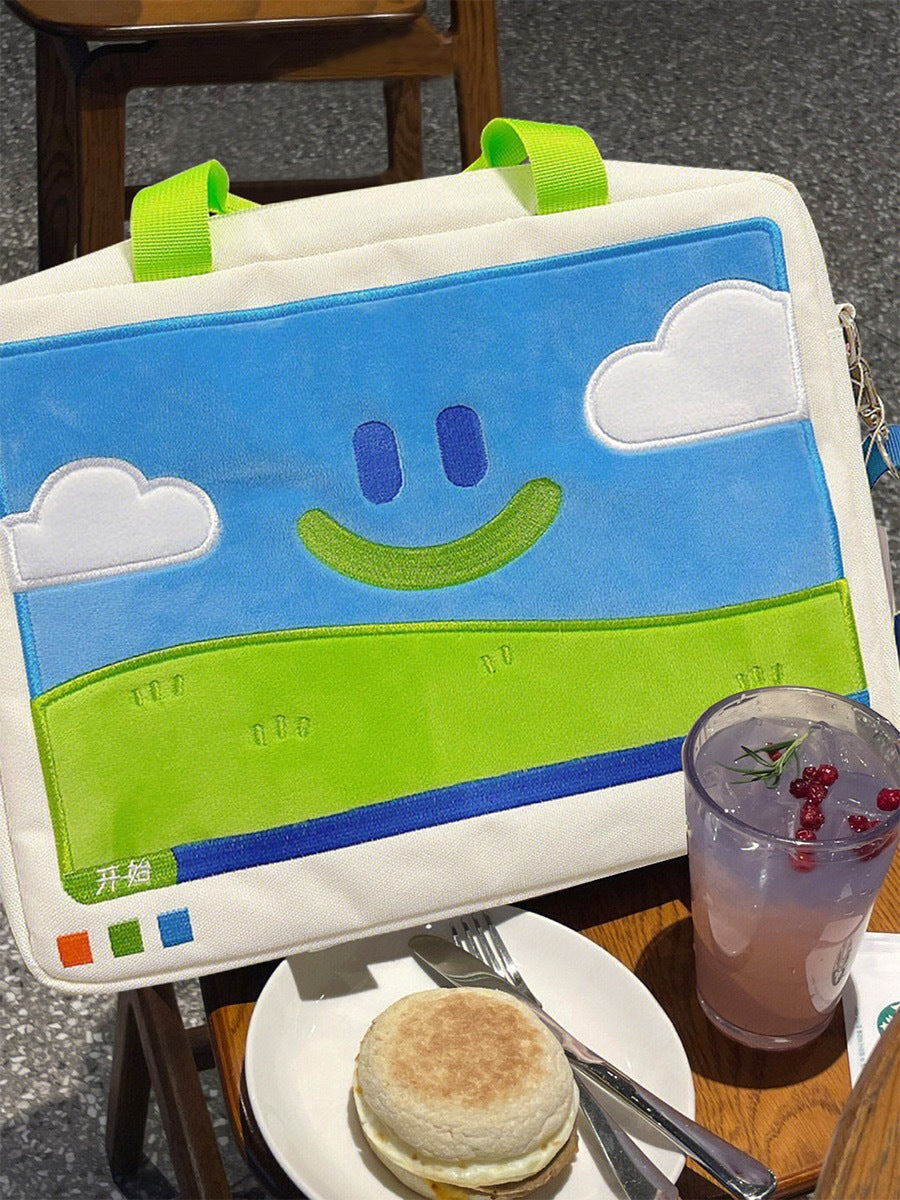 Children's drawing board with a smiley face design on a table with a muffin and drink.