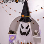 Halloween-themed decoration with a ghost and witch hat on a shelf.