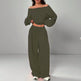 Green off-shoulder top and wide-leg pants set on a gray background
