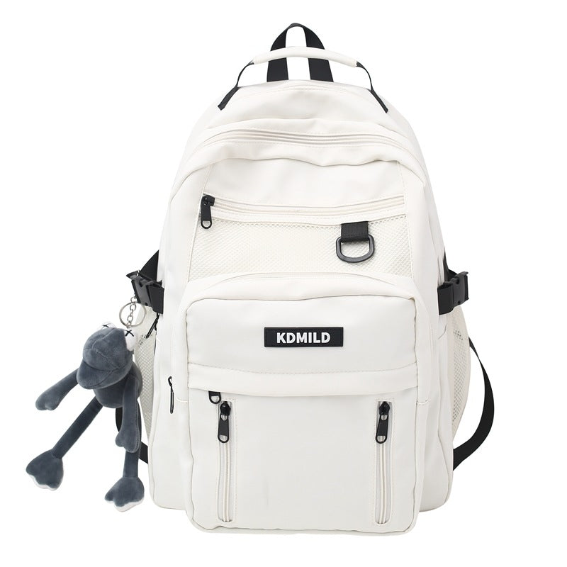 White backpack with black straps and a small gray plush toy attached, on a white background.