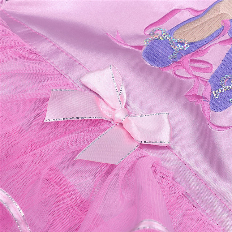 Close-up of a pink ballet outfit with a bow and shoes on a matching pink background