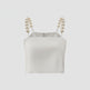 White crop top with pearl straps on a light gray background