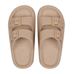 Pair of beige sandals with buckle straps on a white background