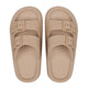 Pair of beige sandals with buckle straps on a white background