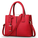 Red handbag with a strap on a white background