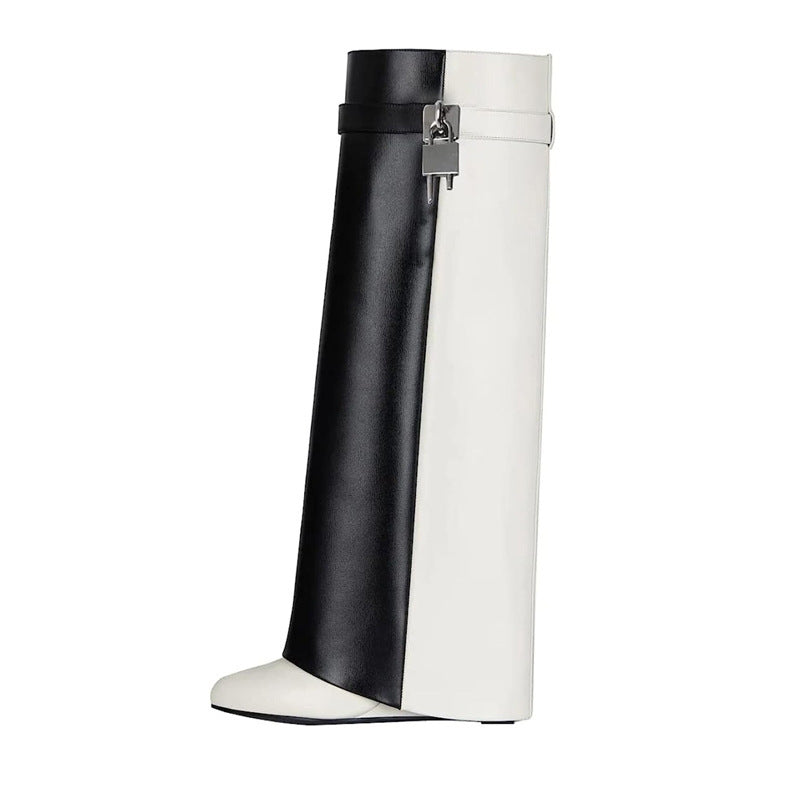 A single mid-calf boot with a color-blocked design featuring a black leather panel on the left and a white leather panel on the right, finished with a white pointed toe and a silver-toned metal buckle detail at the top.