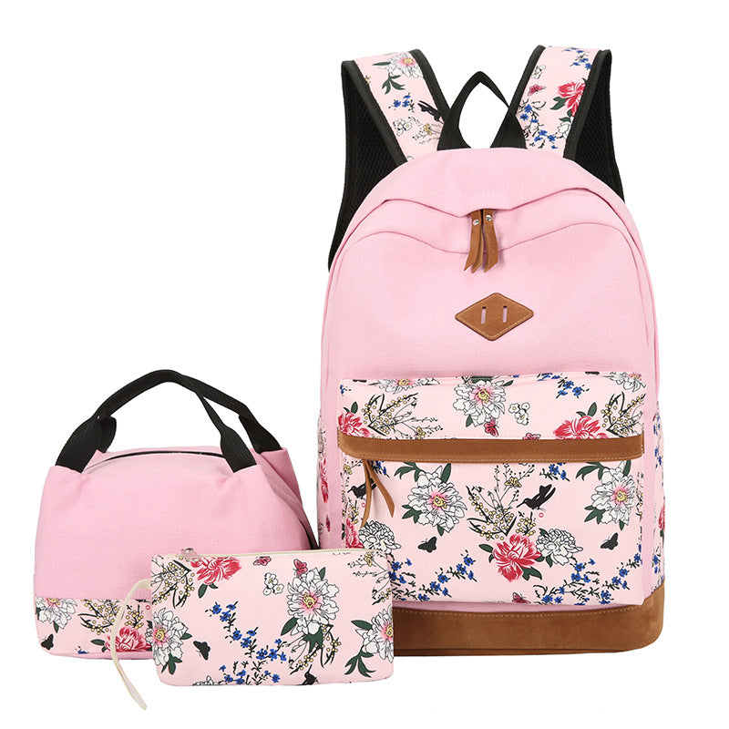 Pink floral backpack with matching lunch bag and pouch on a white background