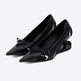 Black pointed-toe shoes with bow details on a white background