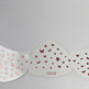 Butterfly wing-shaped nail art stencil with pink and red butterfly designs on a gray background