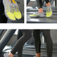 A collage showing a pair of athletic running shoes in bright neon yellow and gray, worn by a person on a treadmill in a gym setting. The image includes close-up views of the shoes and full lower-body views of the person wearing them.